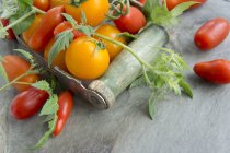 Various tomatoes with leaves — Stock Photo
