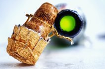 Champagne cork and an open bottl — Stock Photo