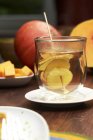 Hot ginger water in glass over table — Stock Photo