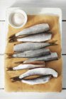 Fresh herrings on parchment paper — Stock Photo