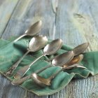 Closeup view of assorted silver spoons on felt cloth — Stock Photo