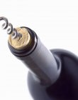 Closeup view of corkscrew in a wine cork in a bottle — Stock Photo
