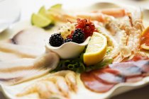 Closeup view of mixed starters with prawns and carpaccio of tuna and swordfish — Stock Photo