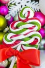 Christmas lollipop on baubles — Stock Photo