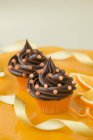 Chocolate cupcakes with sugar confetti — Stock Photo