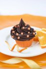 Cupcake with sugar confetti and oranges — Stock Photo