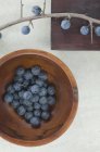 Sloes in wooden bowl — Stock Photo