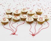 Cupcakes with white glaze and letters — Stock Photo