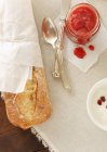 Fresh strawberry jam and baguette — Stock Photo