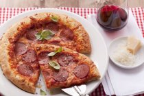 Pizza with salami and basil — Stock Photo