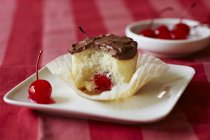 Maraschino Cherry Filled Vanilla Cupcake — Stock Photo