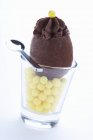Chocolate mousse on yellow sugar pearls — Stock Photo
