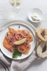 Smoked salmon with capers and onions — Stock Photo