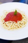 Spaghetti topped with tomato sauce — Stock Photo