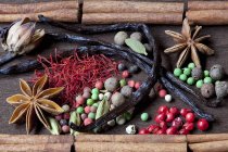 Closeup view of various spices on wooden surface — Stock Photo