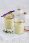 Vichyssoise in jars over white table surface — Stock Photo