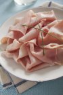 Cooked ham slices on platter — Stock Photo