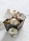 Christmas tree baubles in loaf tin — Stock Photo