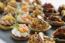 Closeup view of assorted canapes rows — Stock Photo