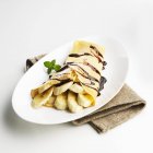 Crepe with banana slices — Stock Photo