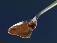 Melted chocolate on spoon — Stock Photo