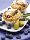Olive muffins on plate with olives — Stock Photo