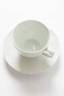 Closeup view of an empty white cup and a saucer — Stock Photo