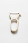 Closeup top view of a one peeler on white surface — Stock Photo
