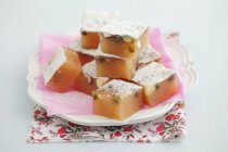 Closeup view of homemade lokum with pistachios and icing sugar — Stock Photo
