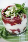 Closeup view of yogurt with strawberries and pistachio nuts — Stock Photo