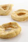 Closeup view of dried apple rings on white surface — Stock Photo