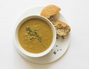 Bowl of vegetable soup with thyme — Stock Photo