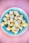 Top view of fresh Gnocchi in a blue bowl — Stock Photo