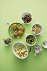 Top view of different snacks on green surface — Stock Photo