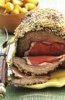 Roasted beef with sesame seed crust — Stock Photo