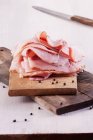 Slices of ham on chopping boards — Stock Photo