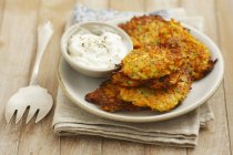 Carrot fritters with yoghurt — Stock Photo