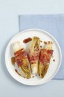 Grilled chicory with ham — Stock Photo