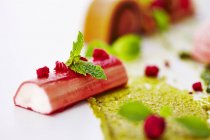 Closeup view of rhubarb with pistachio cream and mint — Stock Photo