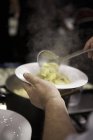Cucchiaio cucchiaio tortellini sul piatto — Foto stock