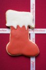 Boot biscuit and Christmas ribbon — Stock Photo