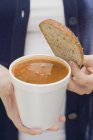 Woman holding tomato soup — Stock Photo