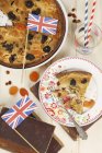 Top view of a dried fruit tart decorated with British flags — Stock Photo