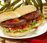 Hamburgers with tomatoes and lettuce — Stock Photo