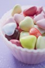 Closeup view of colored hearts in small pink dish — Stock Photo
