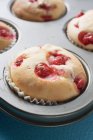 Redcurrant muffins in baking tin — Stock Photo