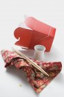 Повышенный вид на пустой контейнер с палочками для еды, маленькой миской и салфеткой — стоковое фото