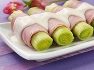 Leeks wrapped in ham — Stock Photo