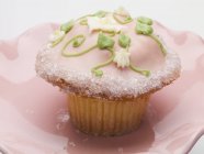 Cupcake with pink icing — Stock Photo