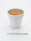 Tomato and vegetable soup in polystyrene cup — Stock Photo